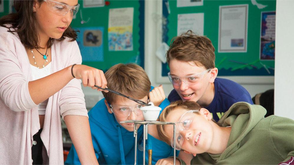 Teacher and students doing chemistry