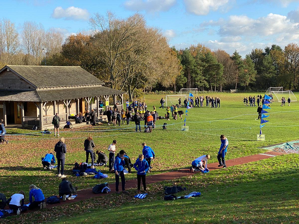 Pupils and adults around Sam banks pavillion in distance
